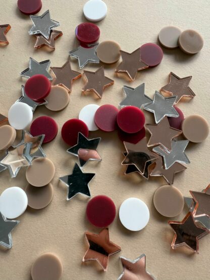 Tischdeko zu Weihnachten Konfetti in Form von Sternen und Talern.